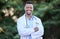 Black man, doctor portrait and arms crossed of healthcare and wellness professional outdoor. Success, motivation and