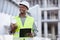 Black man engineer, clipboard and inspection at construction site with mockup in city for planning and safety. Smile