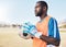 Black man, football and goalkeeper training on field for focus, exercise or gloves for safety in sunshine. Athlete