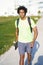 Black man going for a workout in sportswear and a skateboard.