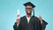 Black man, graduation and thumbs up with diploma and face, smile with pride and celebration on blue background