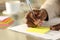 Black man hand writing on sticky note on a desk