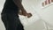 Black man hands keeping chair at kitchen. Closeup hands repairing wooden chair.