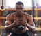 Black man with kettlebell in gym, fitness and focus with arm muscle training, bodybuilder and weightlifting exercise