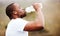 Black man, runner and drinking water with earphones, music or podcast, relax and fitness outdoor. Hydration, health and