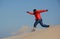 Black man running down dune