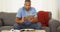 Black man sitting on couch using tablet