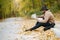 Black man sitting on a road and looking at map