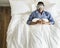 Black man sleeping on bed with eye mask