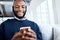 Black man with smartphone, headphones and face, music and smile, scroll social media and audio streaming. Online