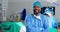 Black man, surgeon and arms crossed, face and confidence with help, support and trust in healthcare. Smile in portrait