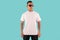 Black man tattooed wearing white short sleeve t-shirt isolated on plain background