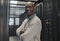 Black man, IT technician in server room and portrait with smile, company mainframe and software update. Network