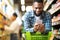 Black Man Using Coupon App For Groceries Shopping In Supermarket