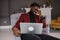 A black man works at a laptop close-up of his face. video conferences