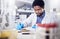 Black man writing report for science study, scientist in lab for research to test and experiment for scientific