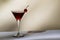Black Manhattan cocktail with whiskey and red vermouth garnished with maraschino cocktail cherry in martini glass. Beige