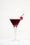 Black Manhattan cocktail with whiskey and red vermouth garnished with maraschino cocktail cherry in martini glass. Beige