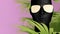 Black mannequin head in golden glasses, with palm leaves on a pink background. The concept of fashion, style, beauty. Pop art.