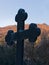 Black marble cross at sunrise in monastery yard, monastery Beocin, mountain Fruska gora