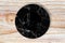 Black marble plate placed on wood.