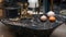 Black marble stone table in luxury house. Gold designer candlestick and decorative bottles on the table