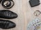 Black men`s shoes with accessories for care. Shoes, dollars, belt, wallet and wristwatch on a wooden background.