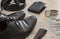 Black men`s shoes with accessories for care. Shoes, dollars, belt, wallet and wristwatch on a wooden background.