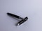 Black metal business fountain pen on white background