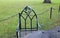 Black metal chair with ornate emblem and arch shapes