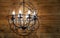 Black metal chandelier with bulb-candles and crystal pendants