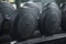 Black metal dumbbell set. Close up many metal dumbbells on rack in gym