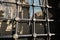 Black and metal fences in windows of a tomb