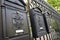 Black metal mailboxes with vintage emblems on a street of Budapest. Close-up. Travel to Europe, vacation