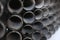 Black metal pipes for gasification or water supply. Industrial background close up