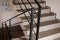 Black metal railings on the porch of the house. Black and white close up of interior stairs of downtown building. iron railings