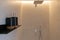 Black metal shelf with decor beige bath shower with chrome taps and ambient LED