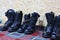 Black military boots  Three pairs of isolate military uniforms on the floor