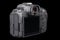 black mirrorless digital camera without lens isolated on black background