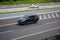 Black Mitsubishi Pajero Sport driving fast on trans jawa highway