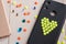 Black mobile phone case decorated with yellow bead heart