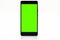 Black mobile phone with a green screen, isolated on a white background with a clipping path.