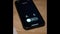 Black mobile phone screen starts to glow after an incoming call from honey. Missed incoming call. Smartphone lies on