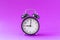 Black modern alarm clock set at nine o`clock, isolated, work school begins concept, ultraviolet background