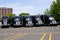 Black modern big rigs semi trucks on parking lot in row