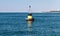 Black modern navigation buoy with yellow stripe