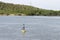 Black modern navigation buoy with yellow stripe floating on a se