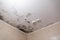 Black mold and mildew spots on the ceiling or wall due to poor air ventilation and high humidity. Harm to health