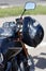 Black moto helmet on motorcycle handlebars