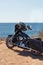 Black motorcycle on beautiful seacoast and blue sky. Prairie, steppe, summer.